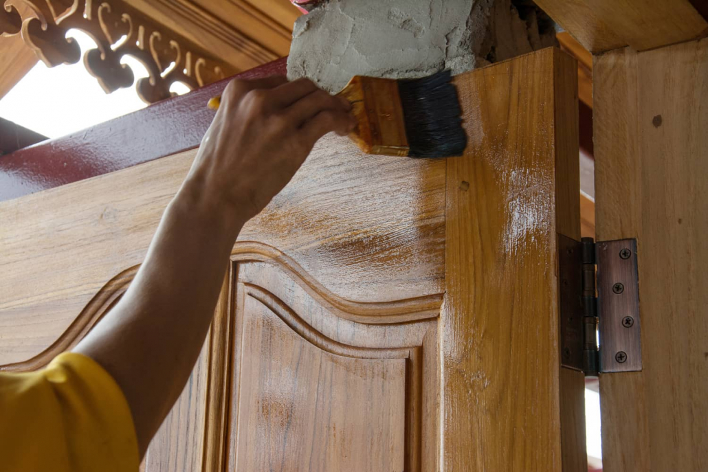 Varnishing a wood door.