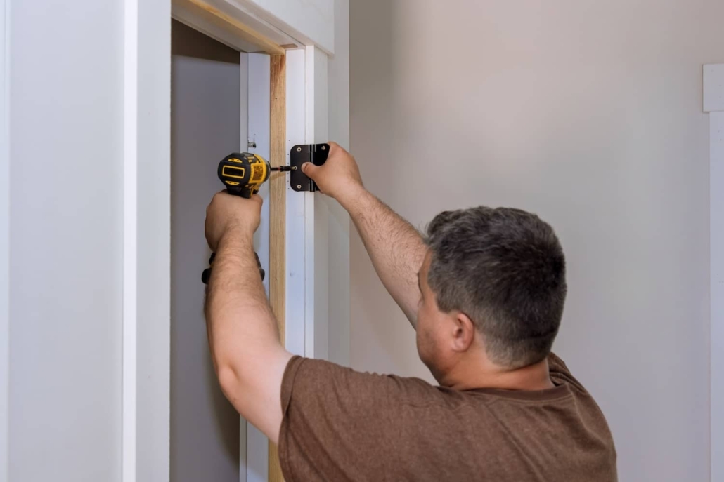 Man working to fix a sagging door